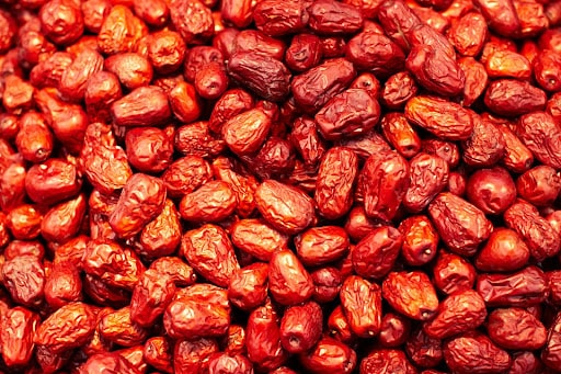 An up-close photo of bright red dates, also known as jujube seeds